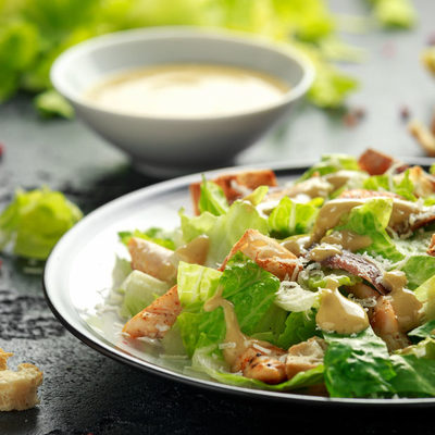 Caesar salad is a fresh, leafy dish that contains romaine lettuce, croutons, cheese, and caesar salad dressing.