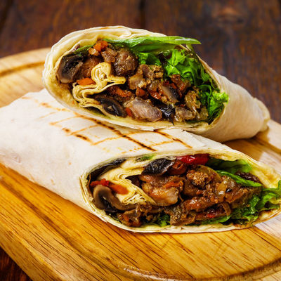 Burrito is a Mexican dish that consists of different ingredients and stuffing mixed and filled into a flour tortilla and rolled like a wrap.