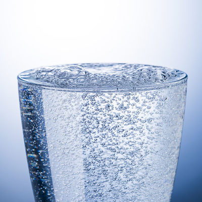 Sparkling water, also known as carbonated water or soda water, is made by dissolving carbon dioxide in it under high pressure.