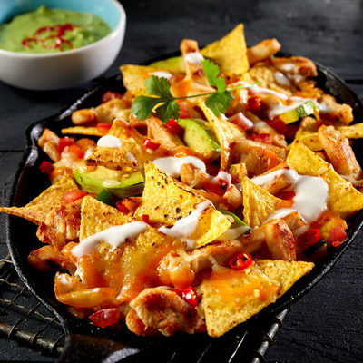 Nachos are a delicious dish that are sometimes served as an appetizer and typically consist of baked tortilla chips covered with melted cheese.