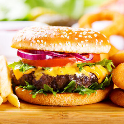 The hamburger is a quintessential American dish made with ground meat cooked into patties and placed inside of a bun.