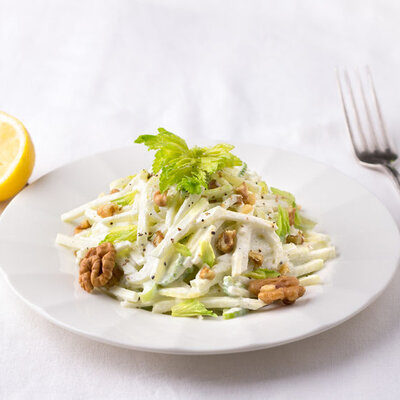 A Waldorf salad is a fresh salad made with fruits and nuts, including apples, grapes, walnuts, and celery.