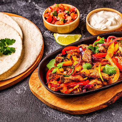 Fajitas are a popular dish in Tex-Mex cuisine made of grilled meat, which can be beef, chicken, or pork.