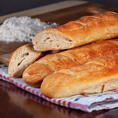 A French baguette is a long loaf of bread with a thin, crunchy crust that is traditionally produced in France.