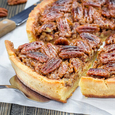 Pecan pie is an American dessert made with a filling of pecans, eggs, butter, and sugar.