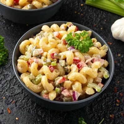 Macaroni salad is a type of salad made with elbow macaroni pasta. In the Western world, it contains mayonnaise, red onions, boiled eggs, any type of hard cheese, red pepper, celery, and sweet pickles.