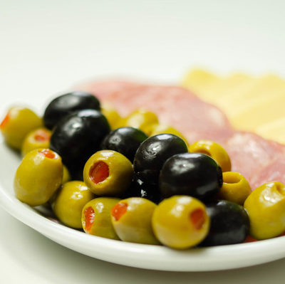 Olives are the edible fruit of the olive tree (Olea europaea) and belong to the drupes group of fruits.