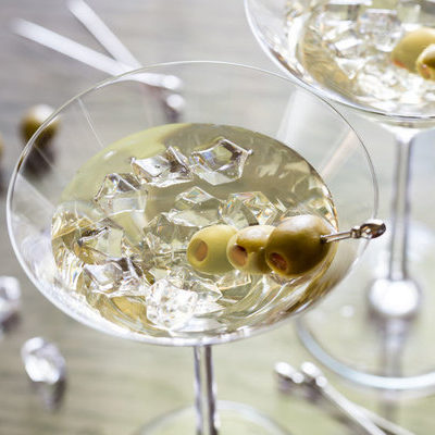 A martini is a cocktail made with gin and dry vermouth, and served with a green olive or a twist of lemon.