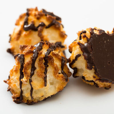 Macaroons are small cookies made from ground almonds, coconut, nuts, sugar, flavorings including vanilla, honey, and spices, as well as a chocolate coating.