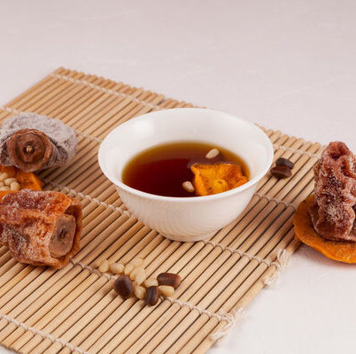 Sujeonggwa is a Korean punch prepared by boiling ginger and cinnamon until their flavors permeate the water.