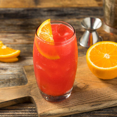 Alabama Slammer is a cocktail made from a mixture of different alcoholic beverages such as amaro, whiskey, and sloe gin, along with orange juice.