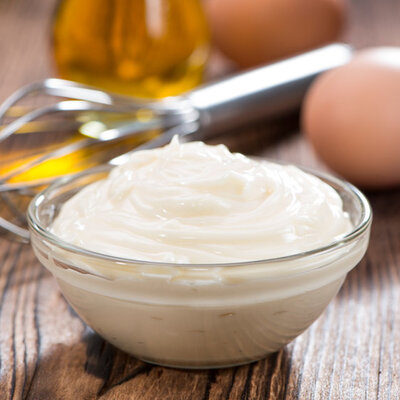 Mayonnaise is a condiment made with oil, egg yolk, and lemon juice or vinegar.