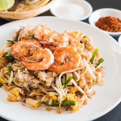 Pad Thai is a Thai dish made with rice noodles and containing meat, peanuts, eggs, bean sprouts, and vegetables.